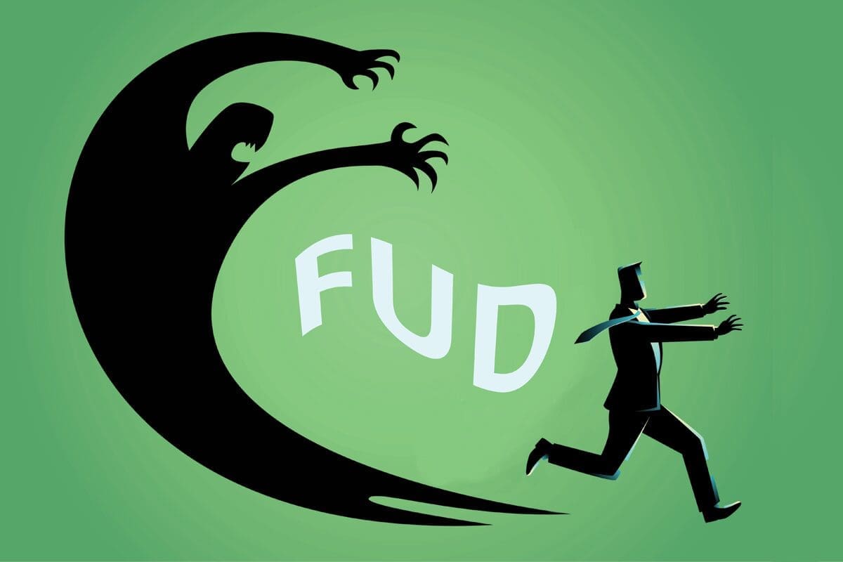 A graphic of a person in a suite, running from their own shadow, with the letters F.U.D. trailing between them - image